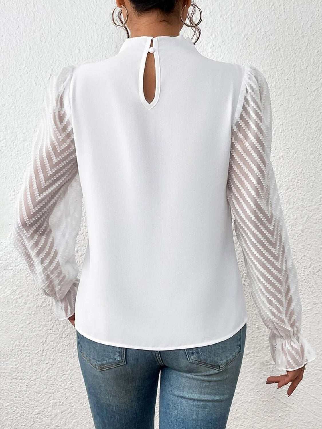 Mock neck blouse with flounce sleeves, semi-sheer design, and slight stretch in white.
