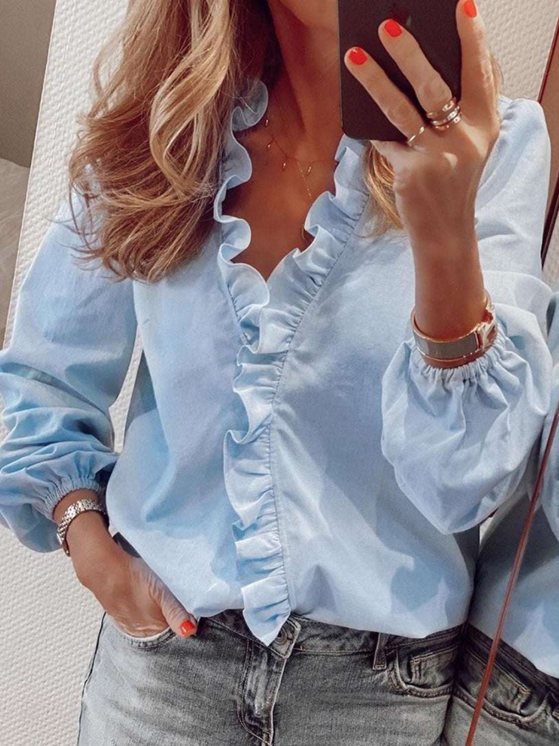 Full size ruffled V-neck long sleeve blouse in light blue with ruffled detailing.