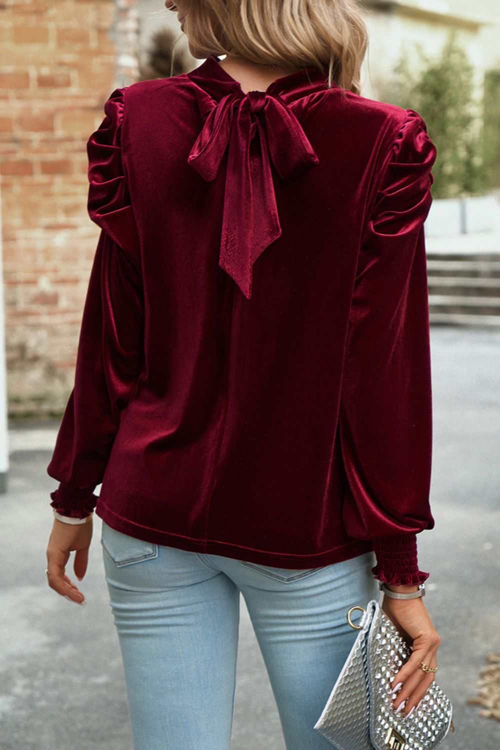 Mock neck velvet blouse with tie-up design and long sleeves.