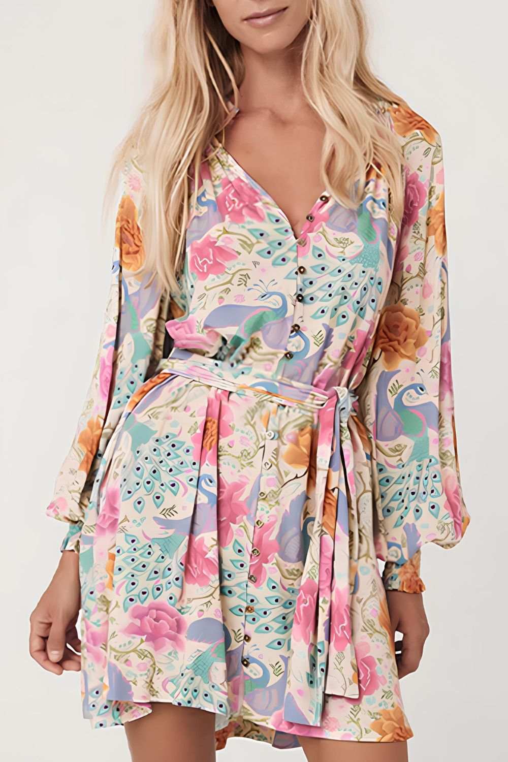 Printed notched lantern sleeve dress with vibrant floral pattern and tie waist.