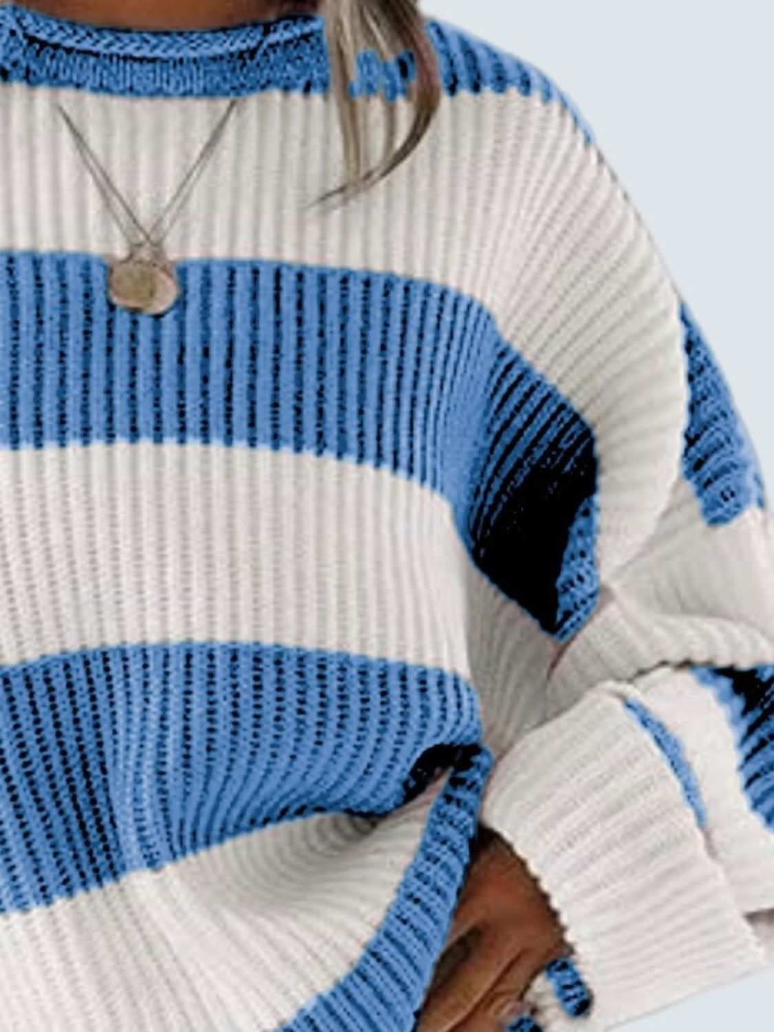 Round neck long sleeve sweater with blue and white stripes.