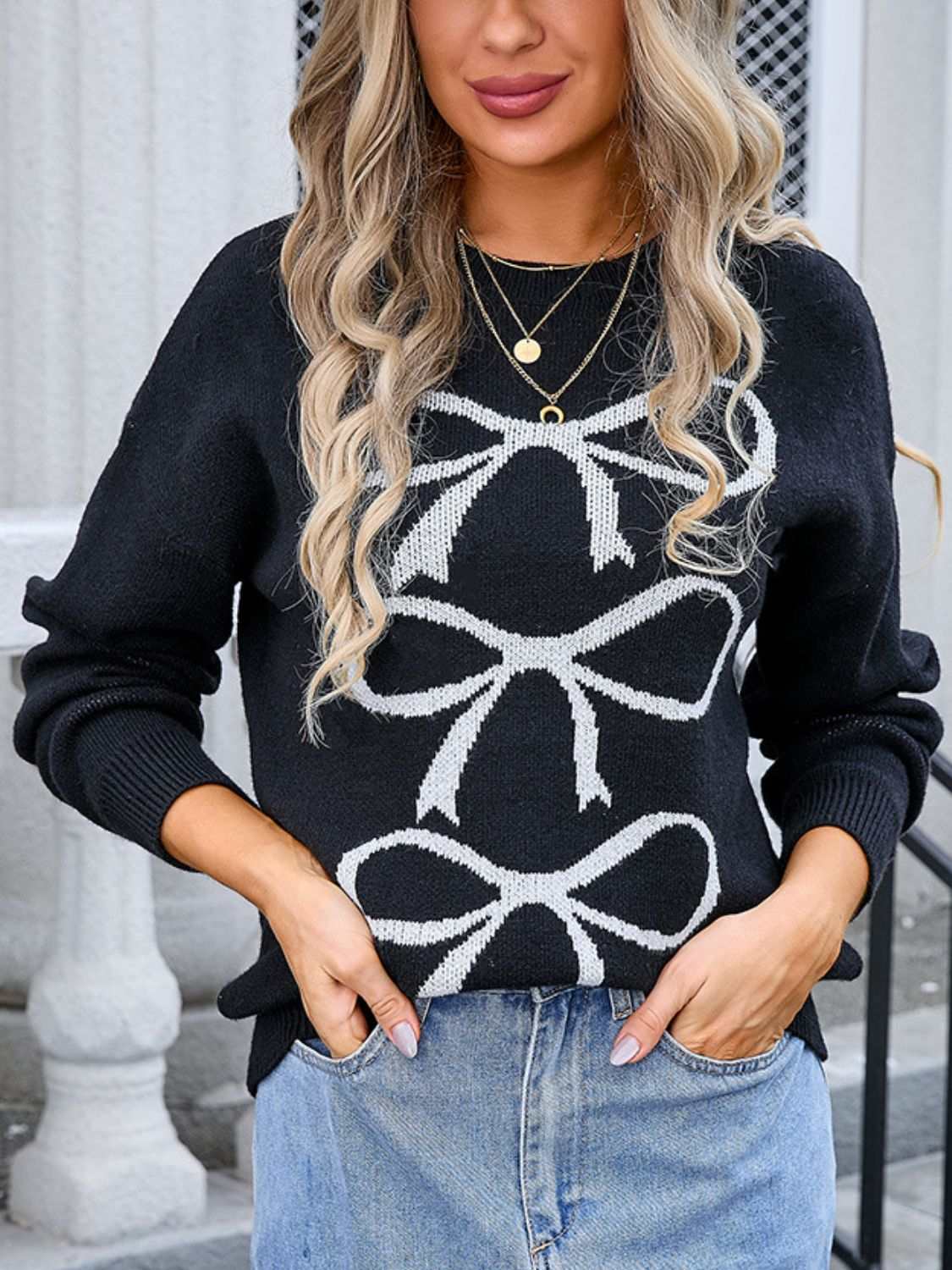 Angel Wings Bow Graphic Round Neck Long Sleeve Sweater in black with white bow design, worn by model.