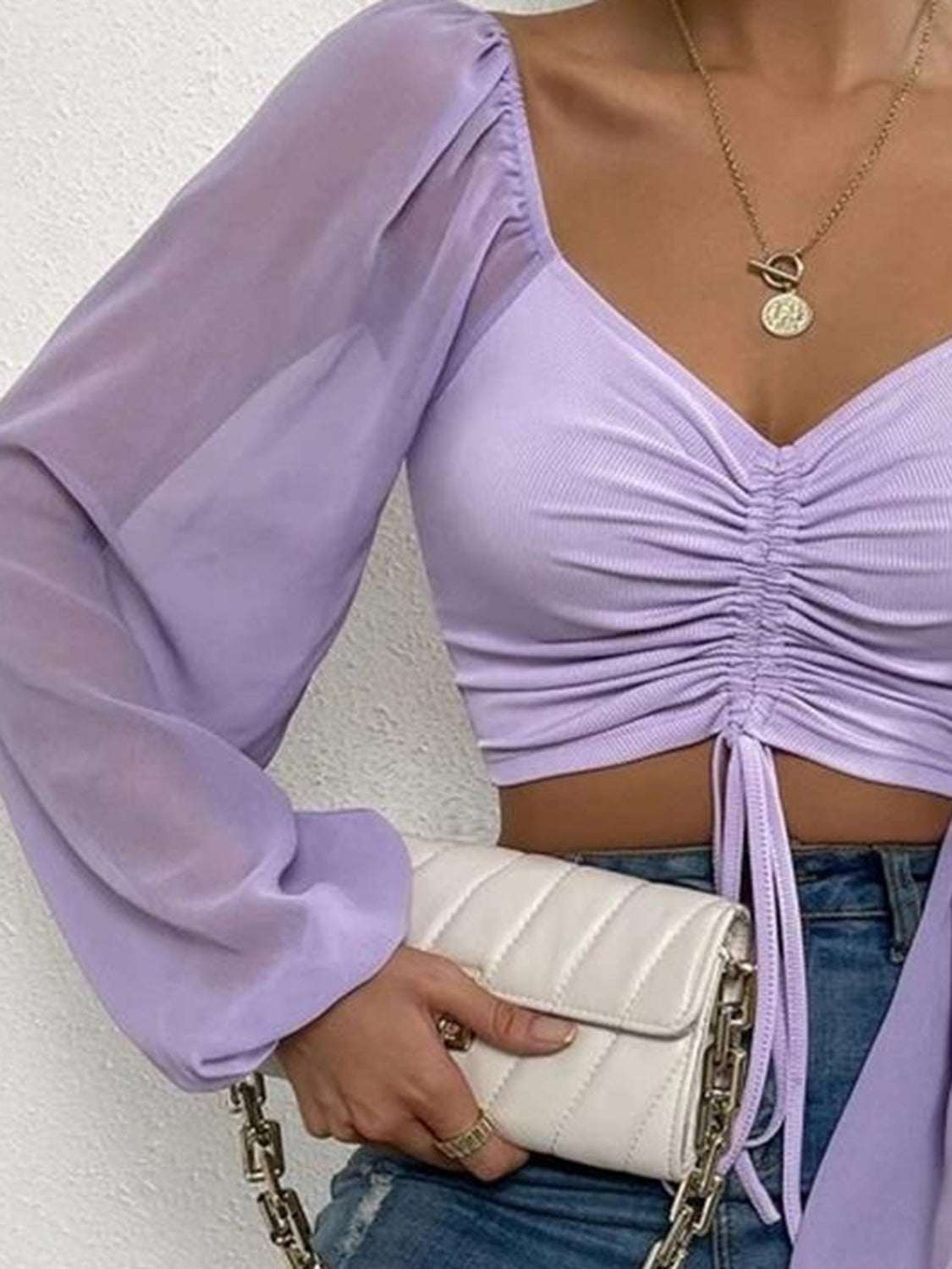 Drawstring sweetheart neck cropped top in purple, semi-sheer with long sleeves, pullover style.