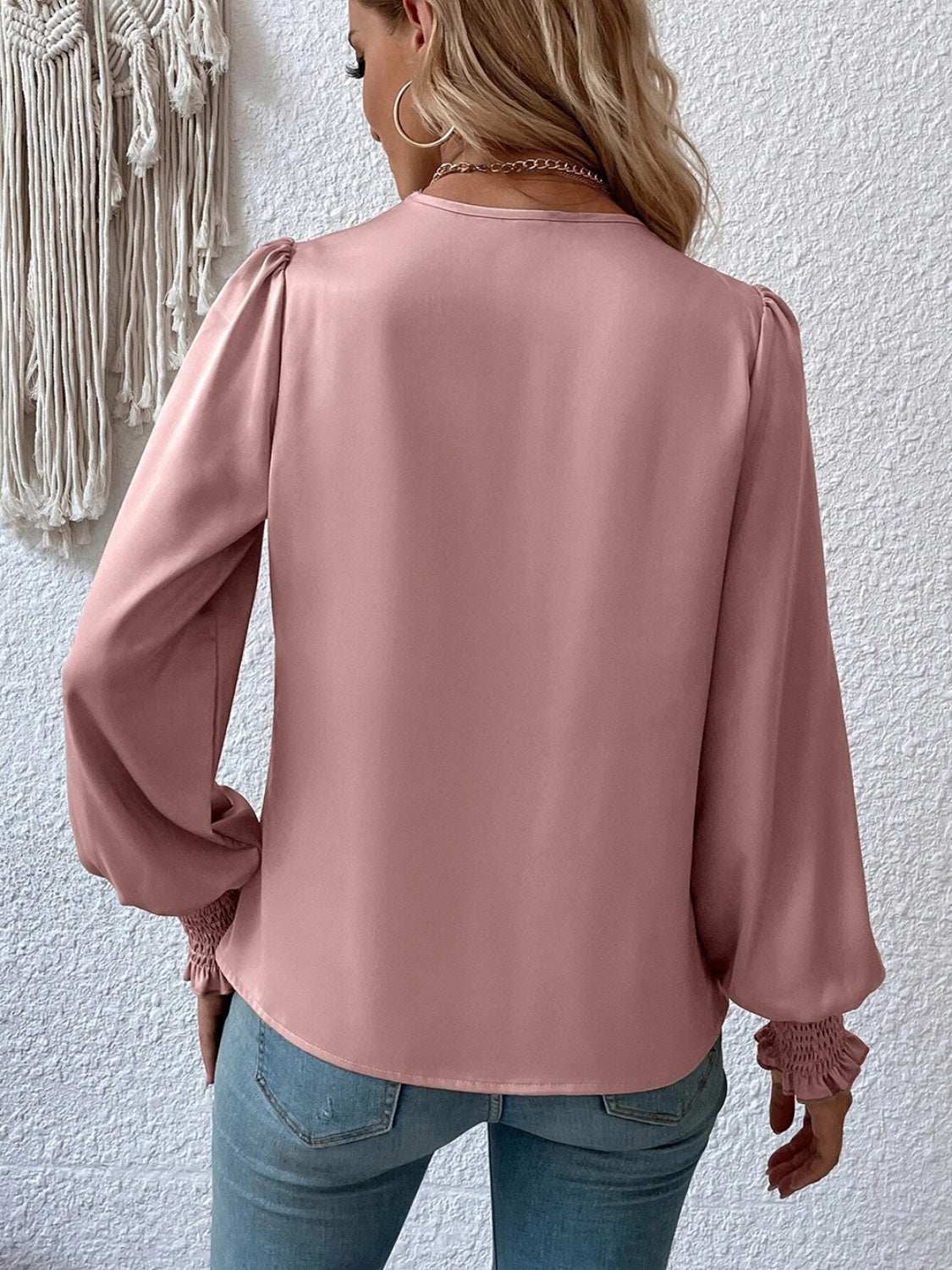 Surplice smocked lantern sleeve blouse in light pink, featuring opaque fabric and a basic style.