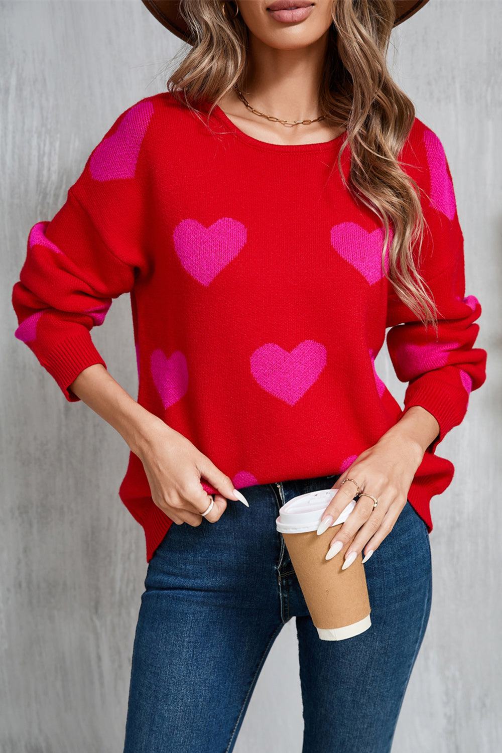 Red heart-patterned round neck dropped shoulder sweater.