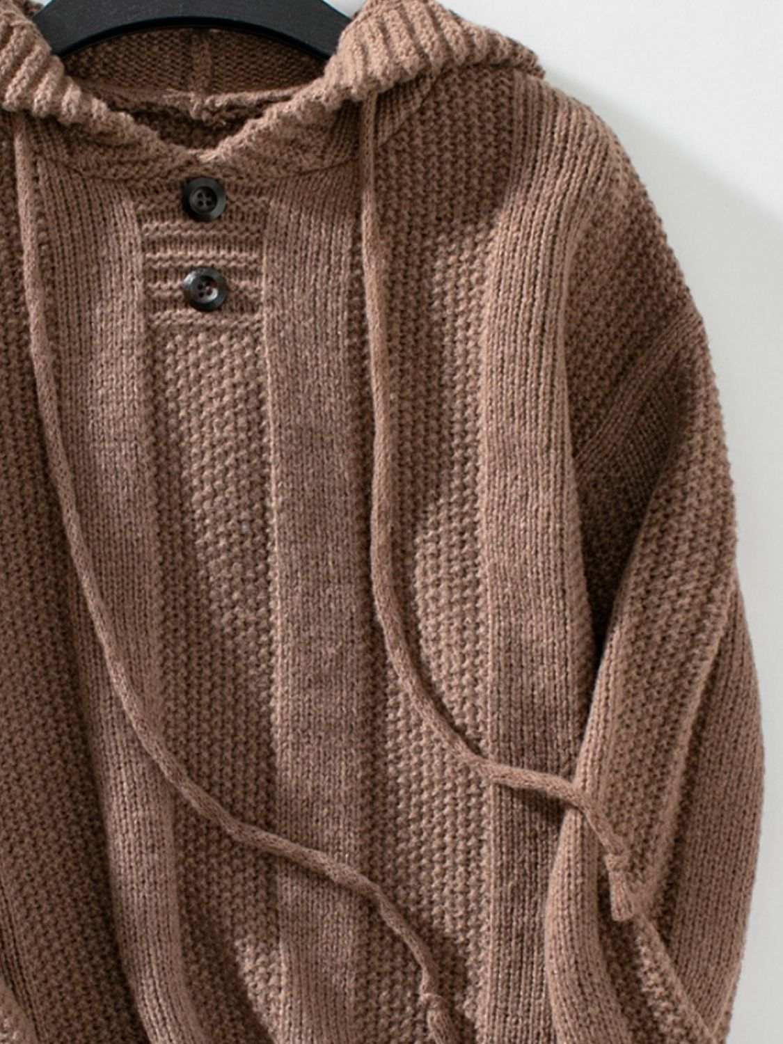 Drawstring long sleeve hooded sweater with decorative buttons and slightly stretchy polyester fabric.