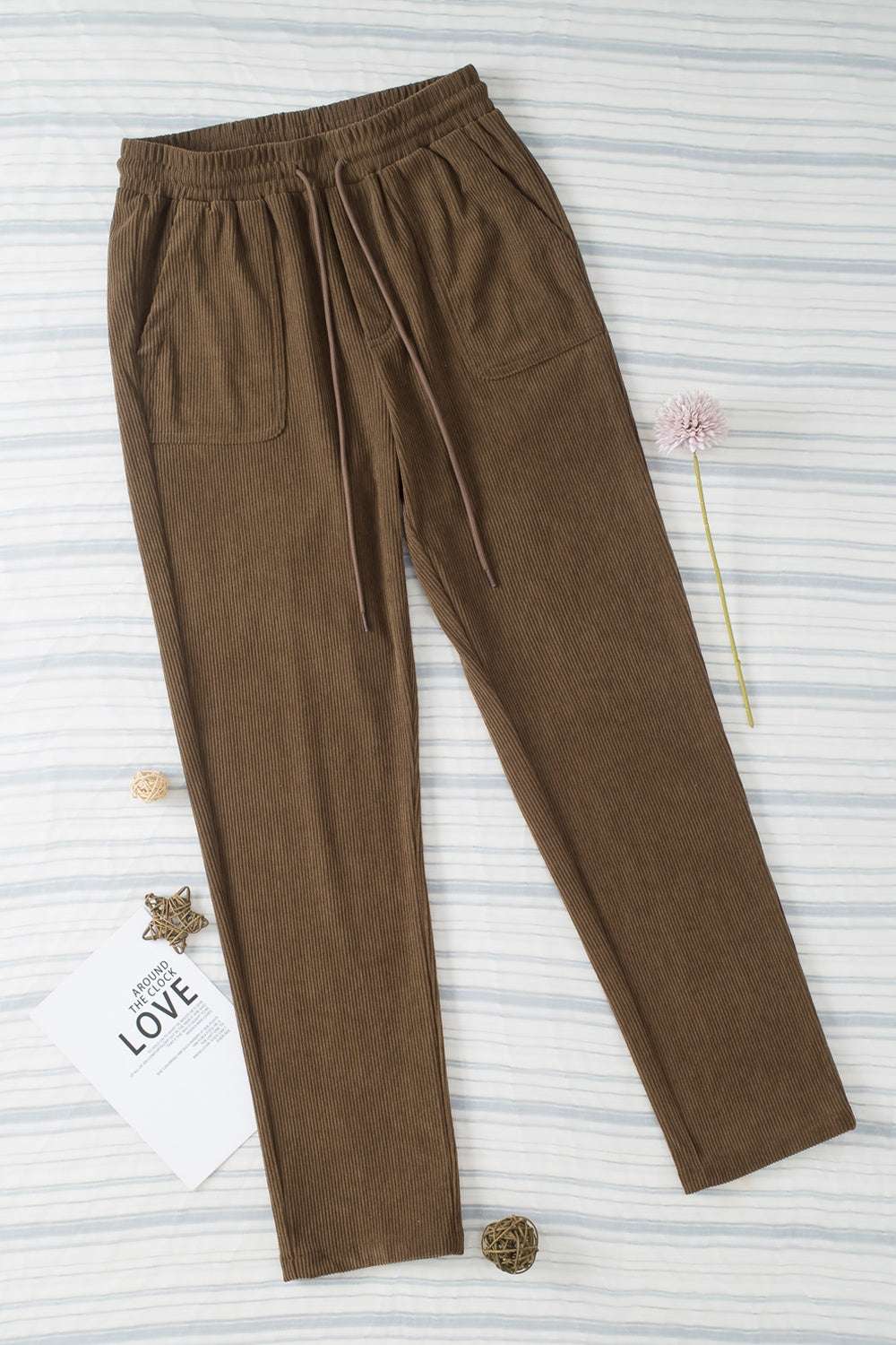 Drawstring straight pants with pockets, polyester material, brown color.