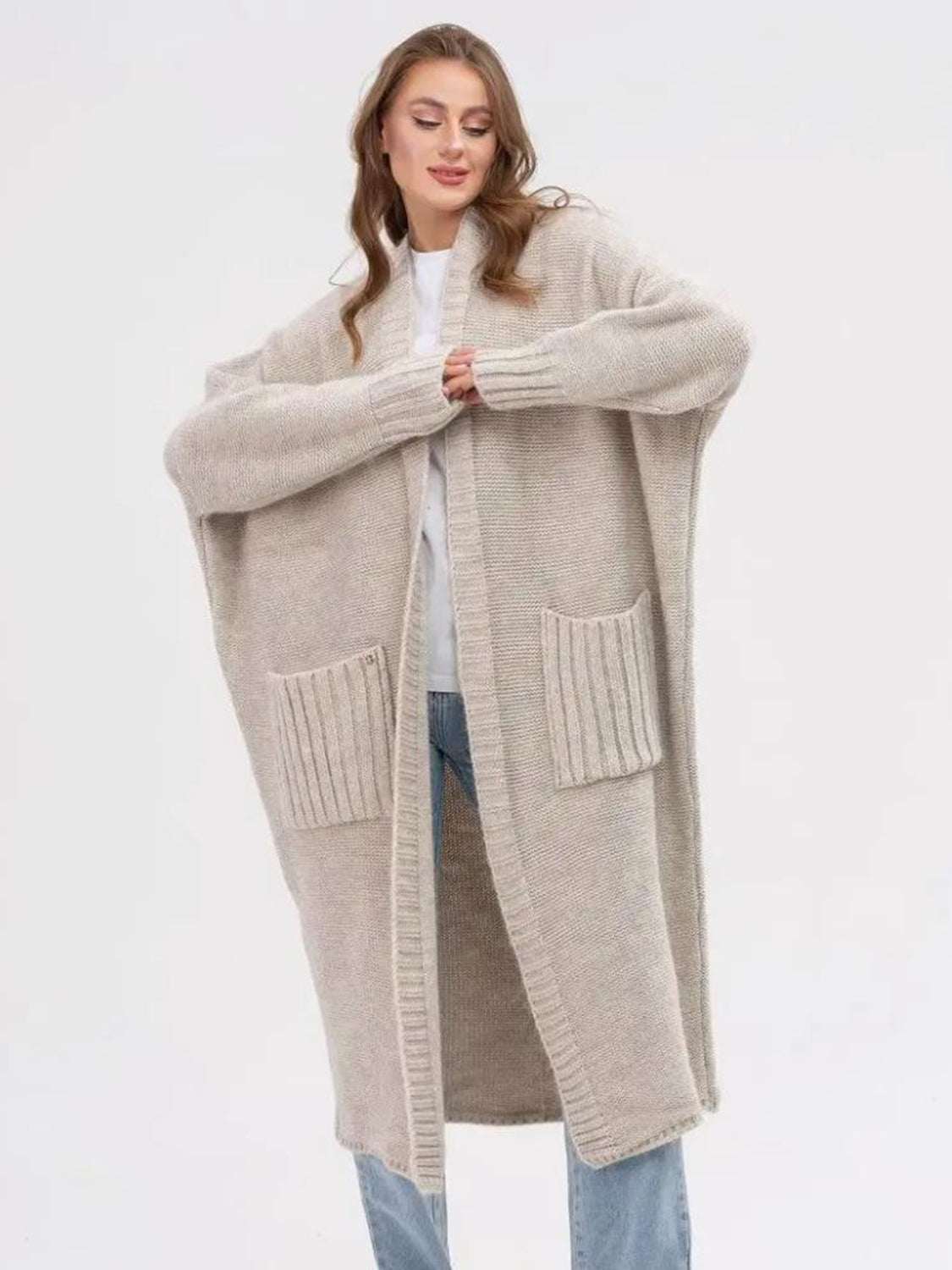 Pocketed open front long sleeve longline cardigan in beige with moderate stretch.
