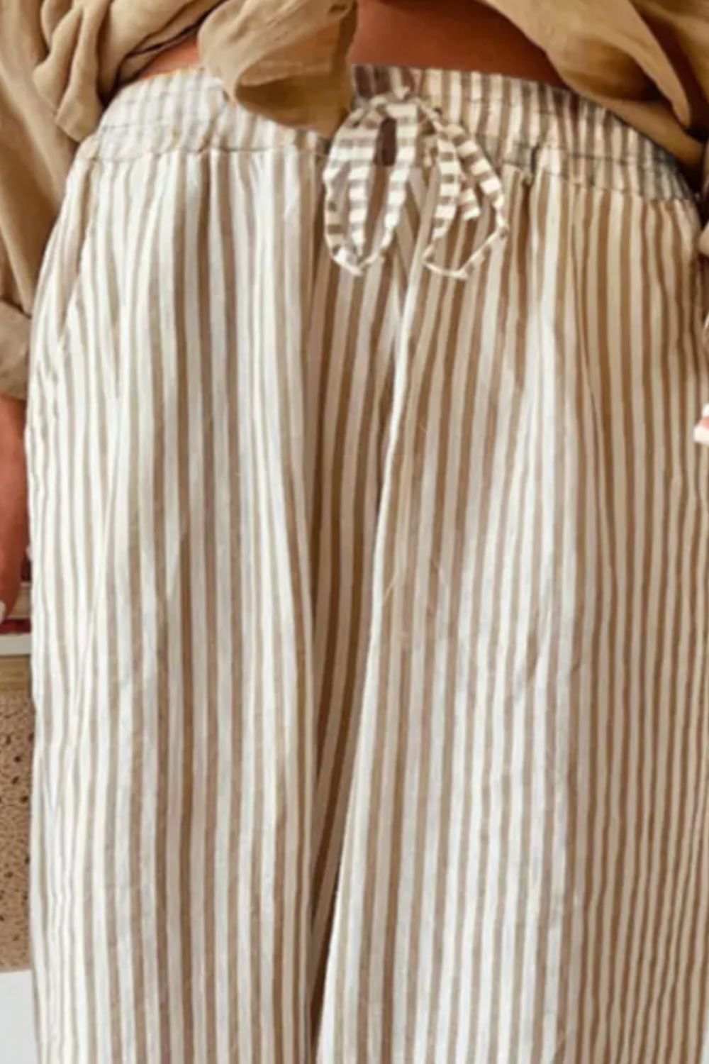 Plus size striped wide leg pants with drawstring, 100% polyester.