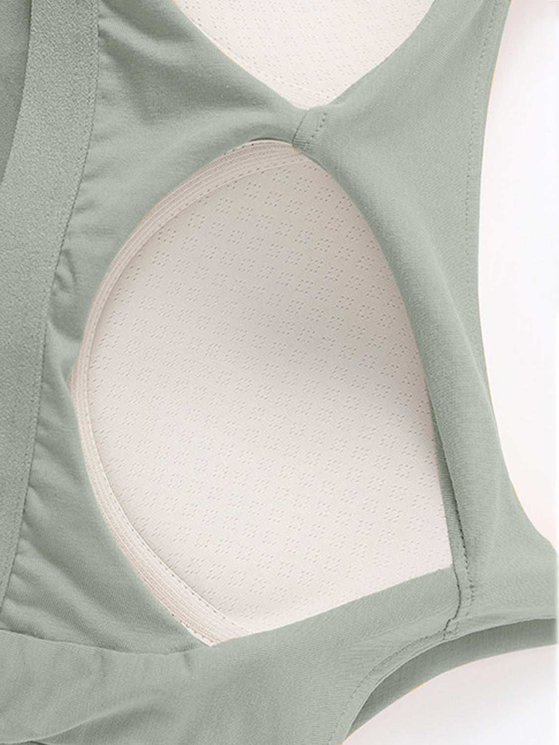 Scoop neck cropped cami with chest pads in green, highly stretchy fabric.
