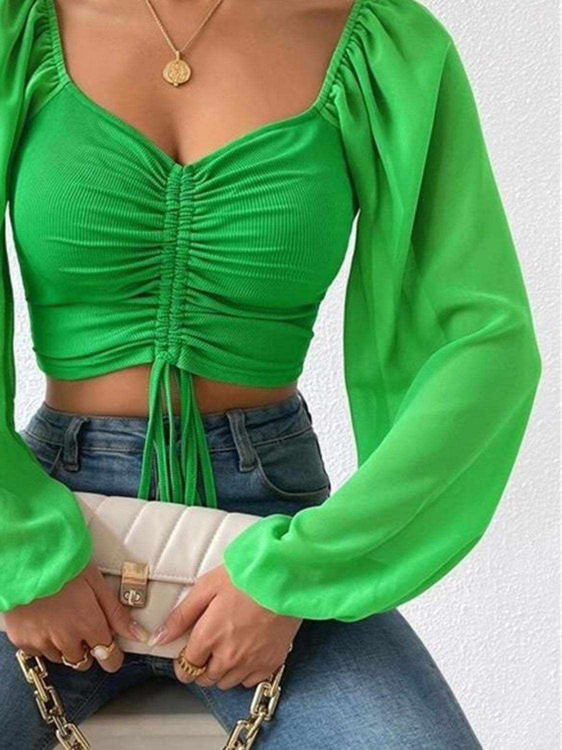 Green drawstring sweetheart neck cropped top with long sleeves.