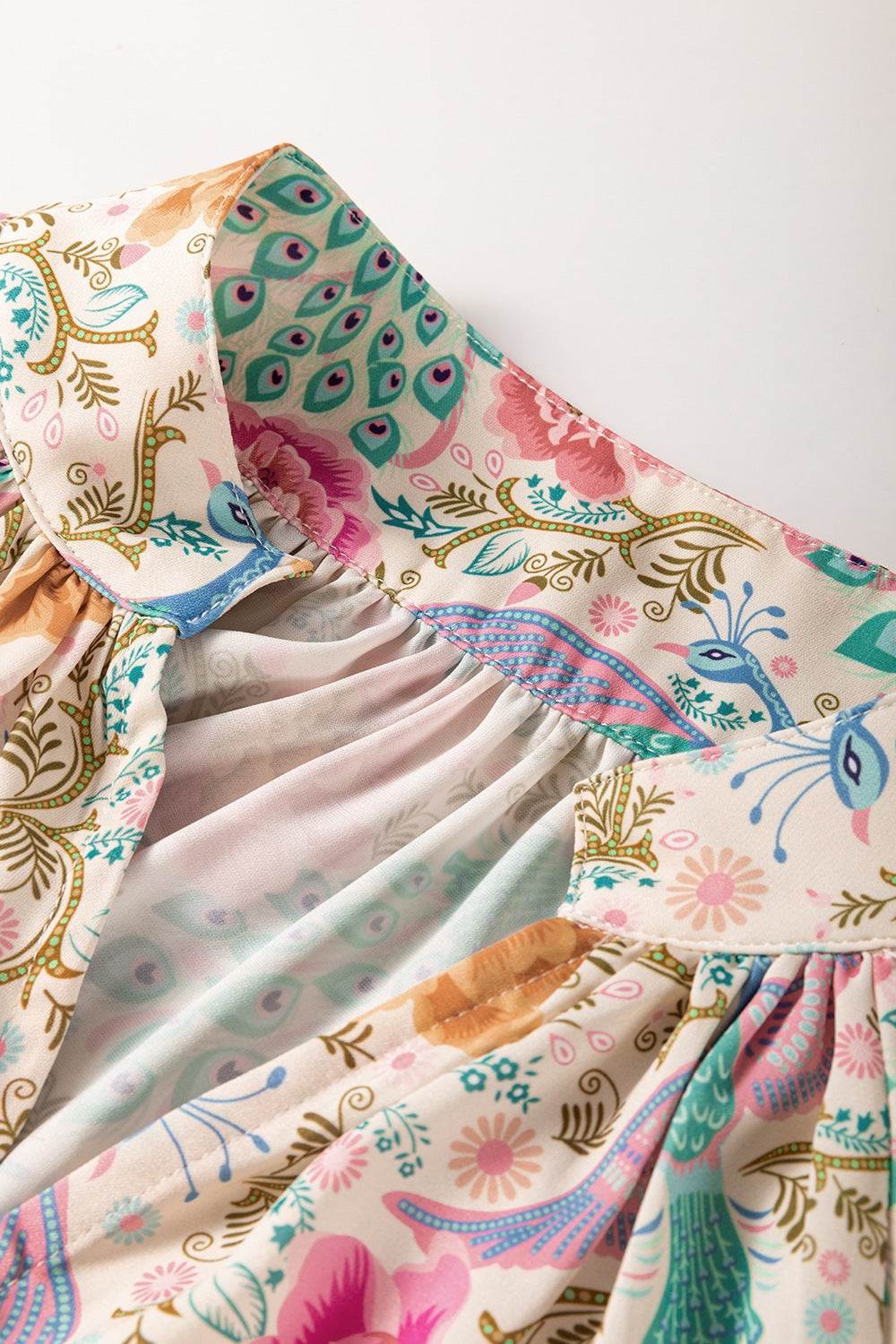 Printed notched lantern sleeve dress with vibrant floral design.