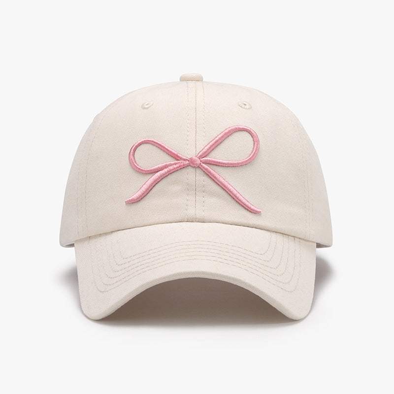 Bow embroidered cotton baseball cap with pink bow design.