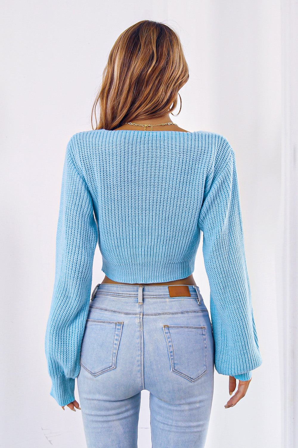 Bow V-neck long sleeve cropped sweater in light blue, back view.