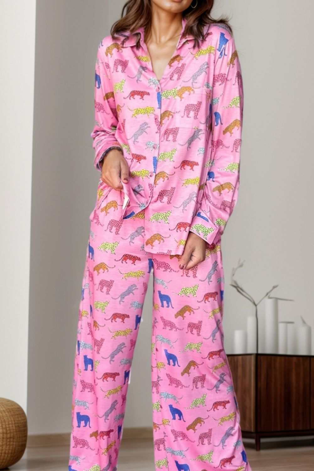 Women's pink pocketed printed top and pants lounge set with animal pattern.