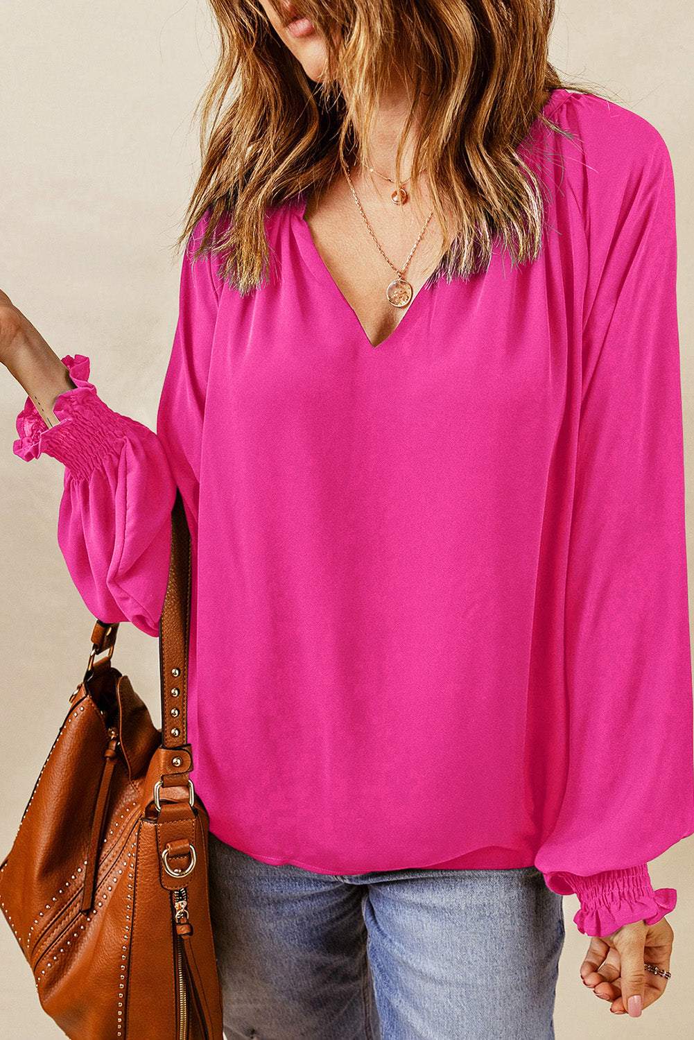 Pink notched neck blouse with smocked lantern sleeves and casual fit