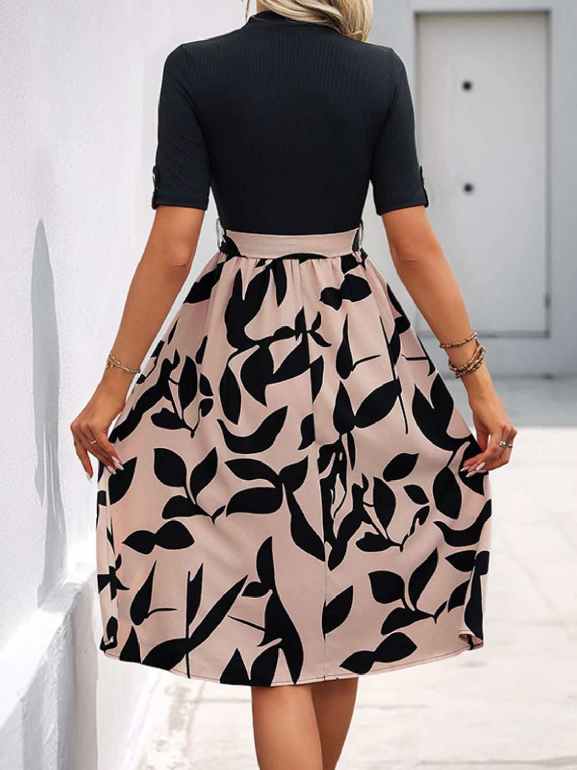 Perfee Tied Printed Mock Neck Short Sleeve Dress with black and beige leaf pattern.