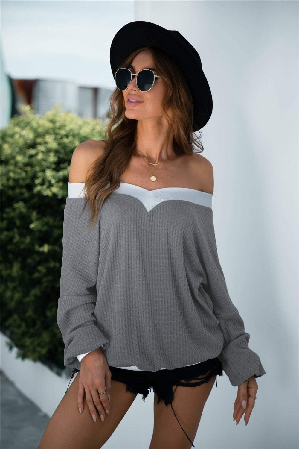 Off-shoulder waffle-knit blouse with lantern sleeves and casual style.