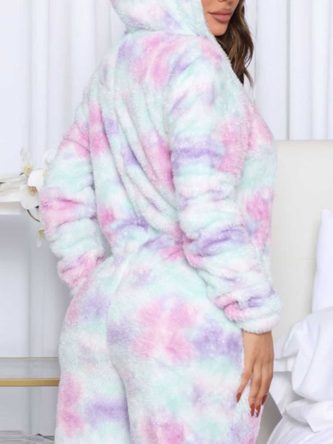 Printed zip up long sleeve hooded lounge jumpsuit in pastel colors with pockets.
