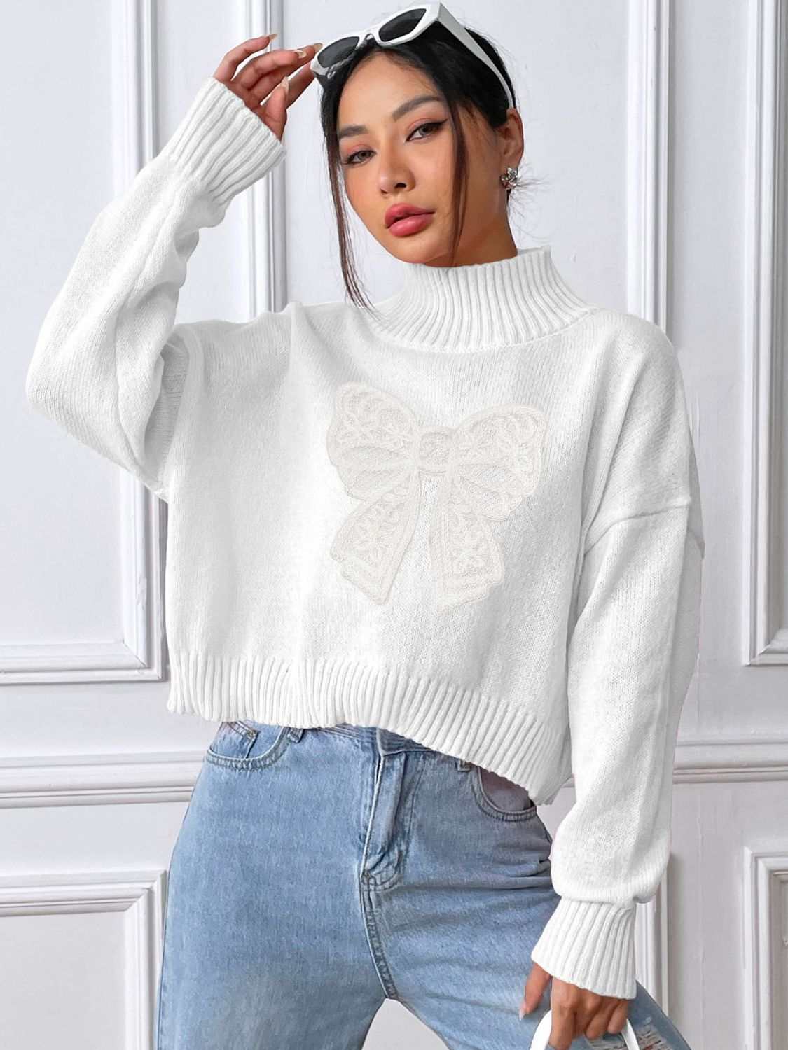 White bow turtleneck long sleeve sweater, slightly stretchy, 100% polyester.