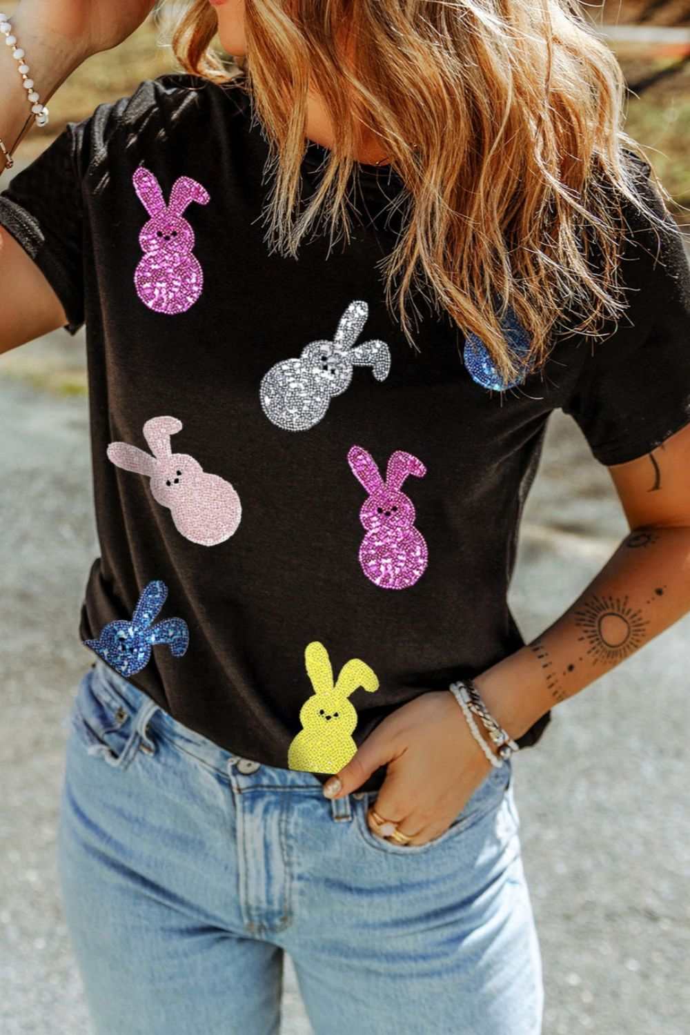 Sequin bunny doll short sleeve t-shirt with colorful sequined bunny designs on a black top.