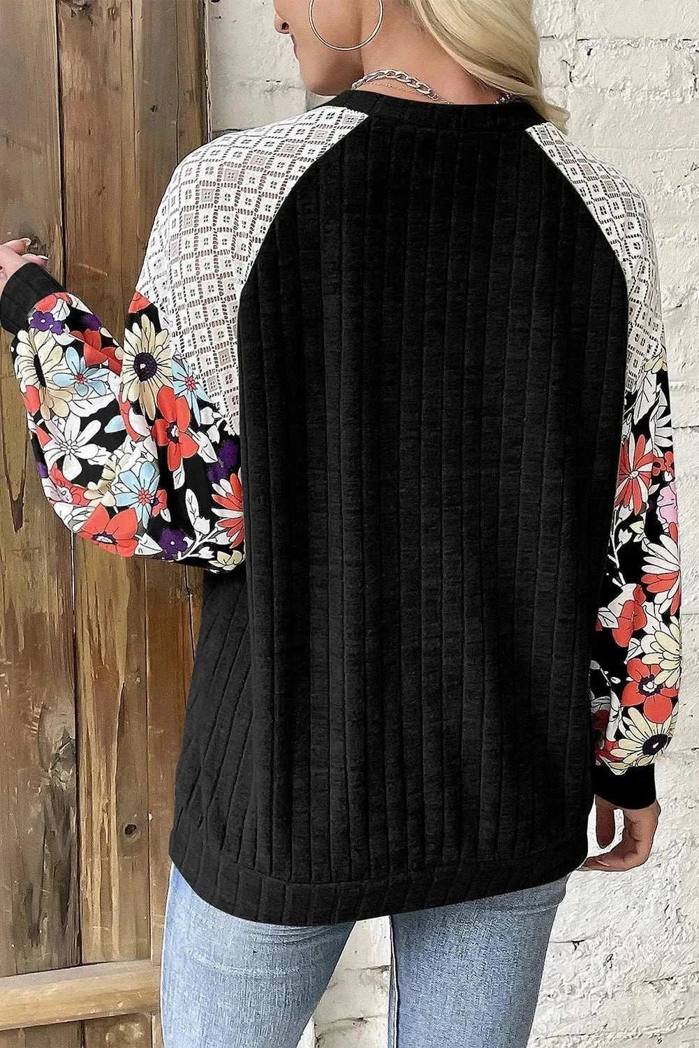 Printed round neck long sleeve top with floral and geometric patterns.