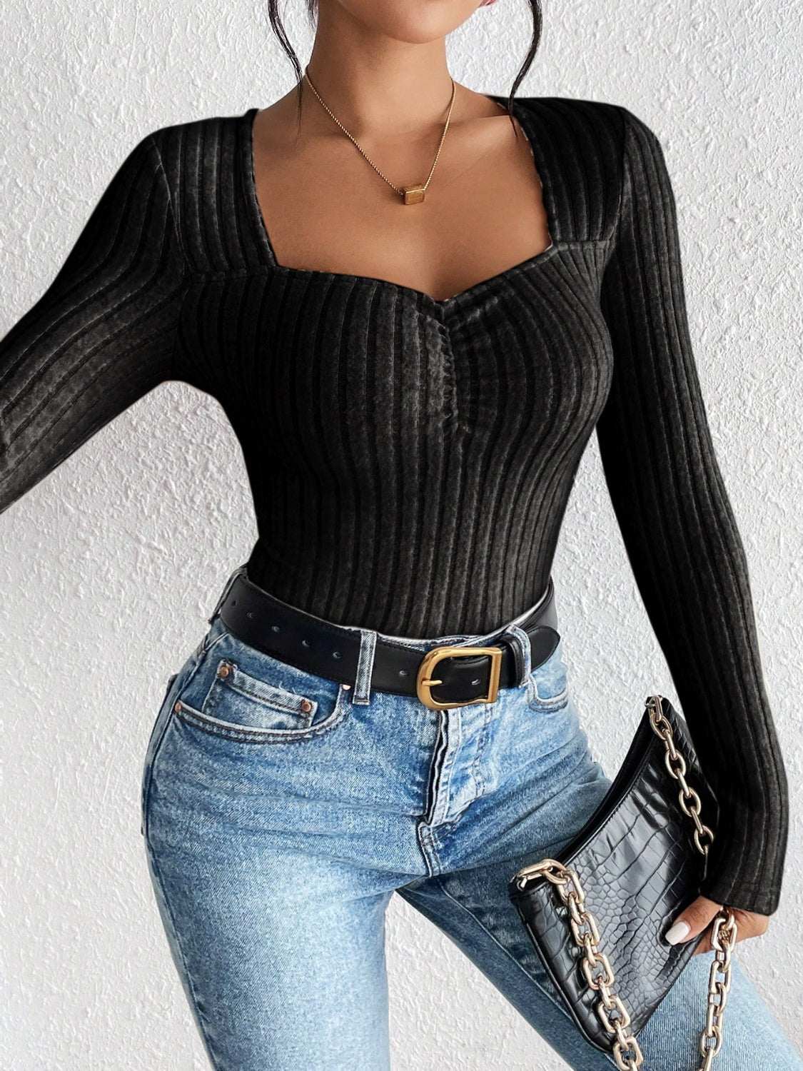 Honey ribbed long sleeve t-shirt in black, slightly stretchy, paired with jeans and a belt.