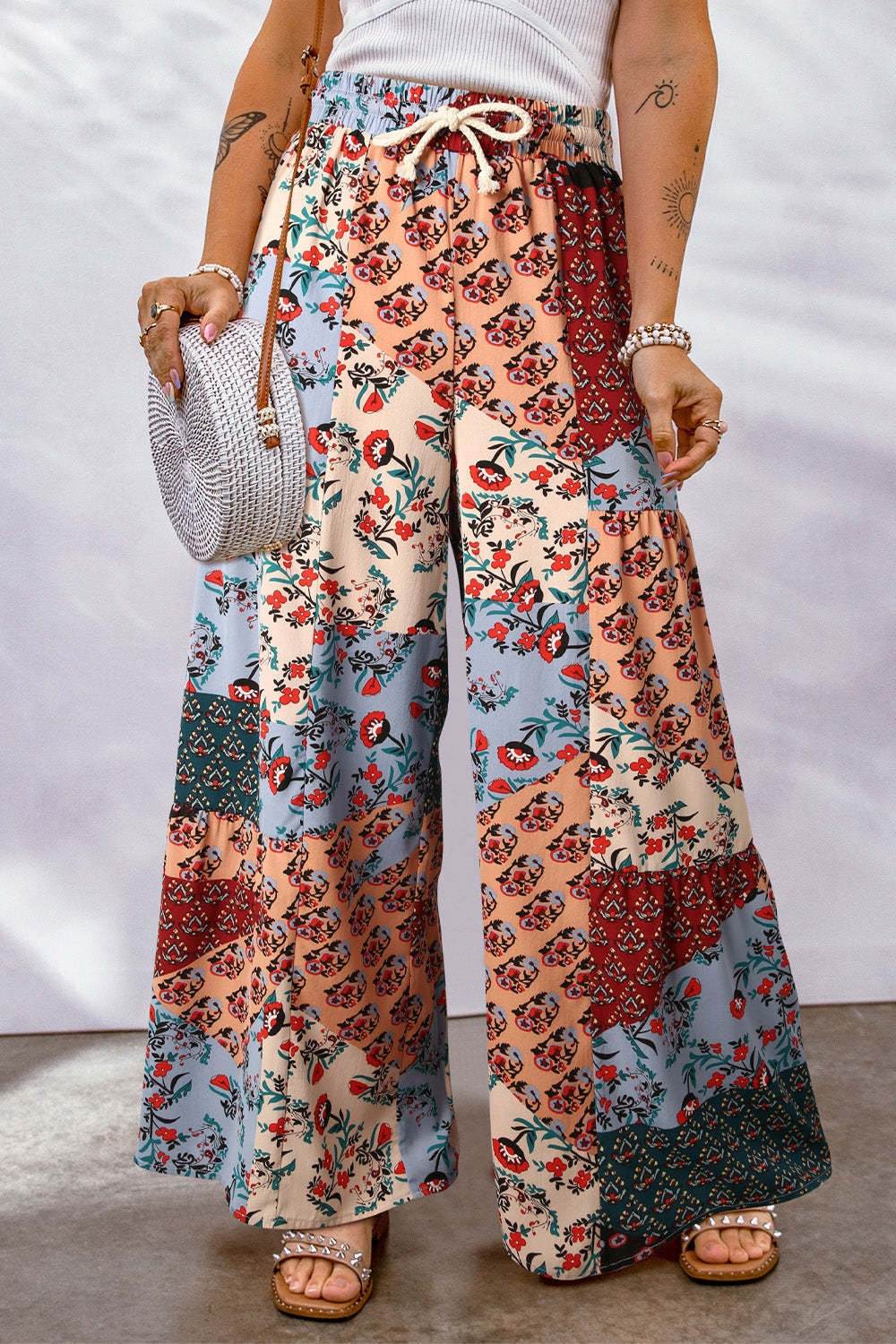 Full size drawstring printed wide leg pants with floral patterns, made of 100% polyester.