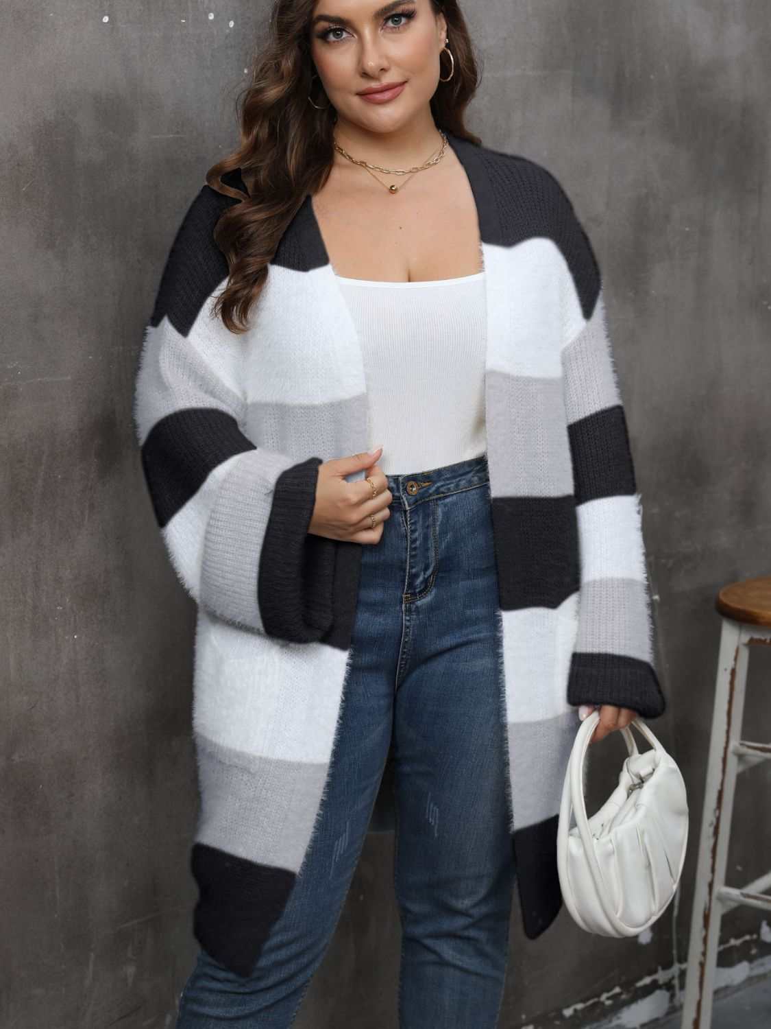 Plus size open front long sleeve cardigan in black, white, and gray color blocks, worn by model.