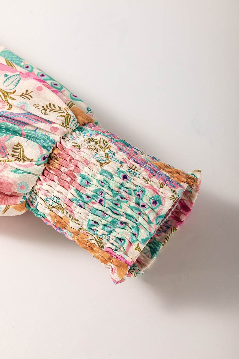 Printed notched lantern sleeve detail of dress.