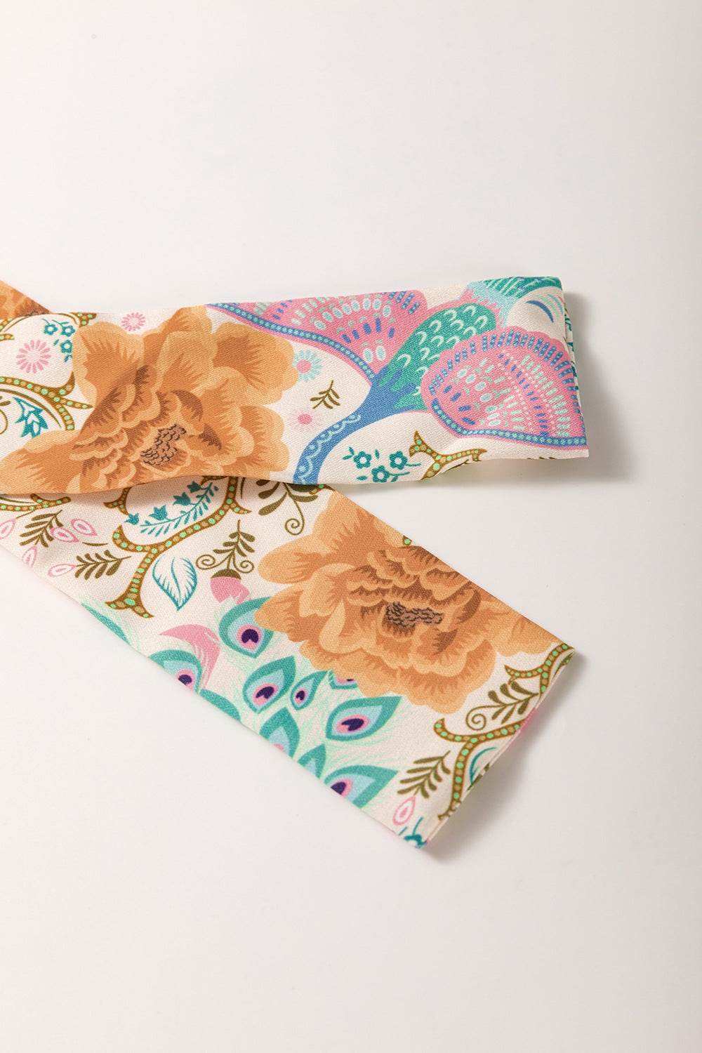 Printed notched dress fabric with floral and paisley design.