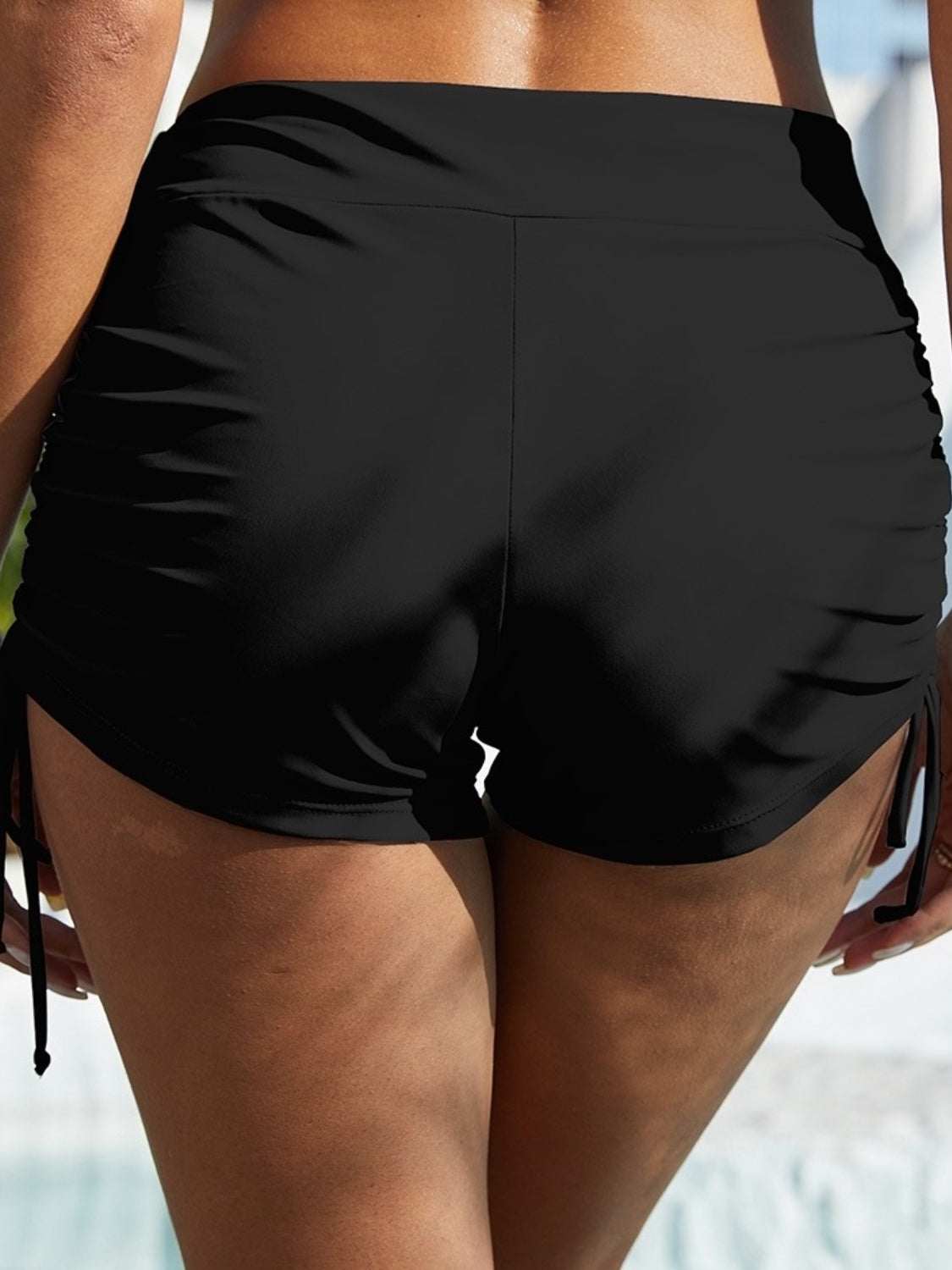 FAM-FAM drawstring mid-rise waist swim shorts in black, slightly stretchy polyester and spandex blend.