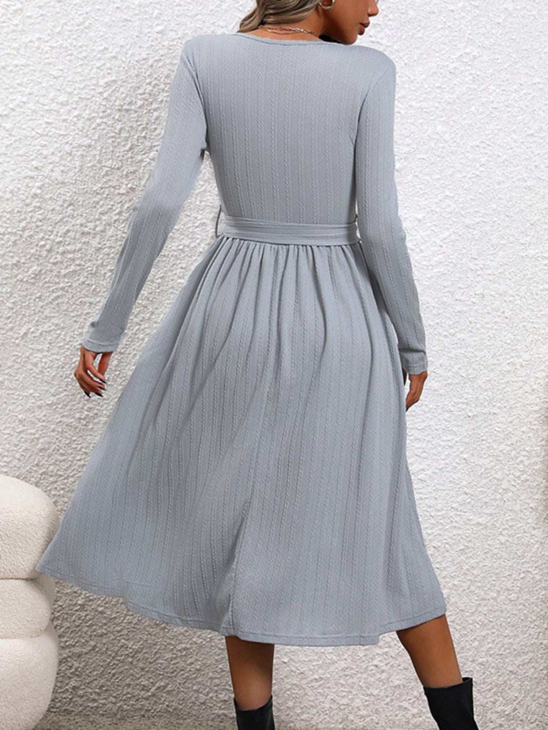 Surplice tie waist long sleeve midi dress, moderate stretch fabric, light blue color, back view.