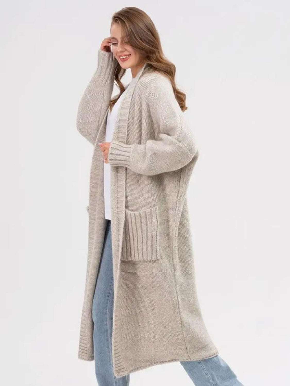 Pocketed open front long sleeve longline cardigan with moderate stretch in beige.
