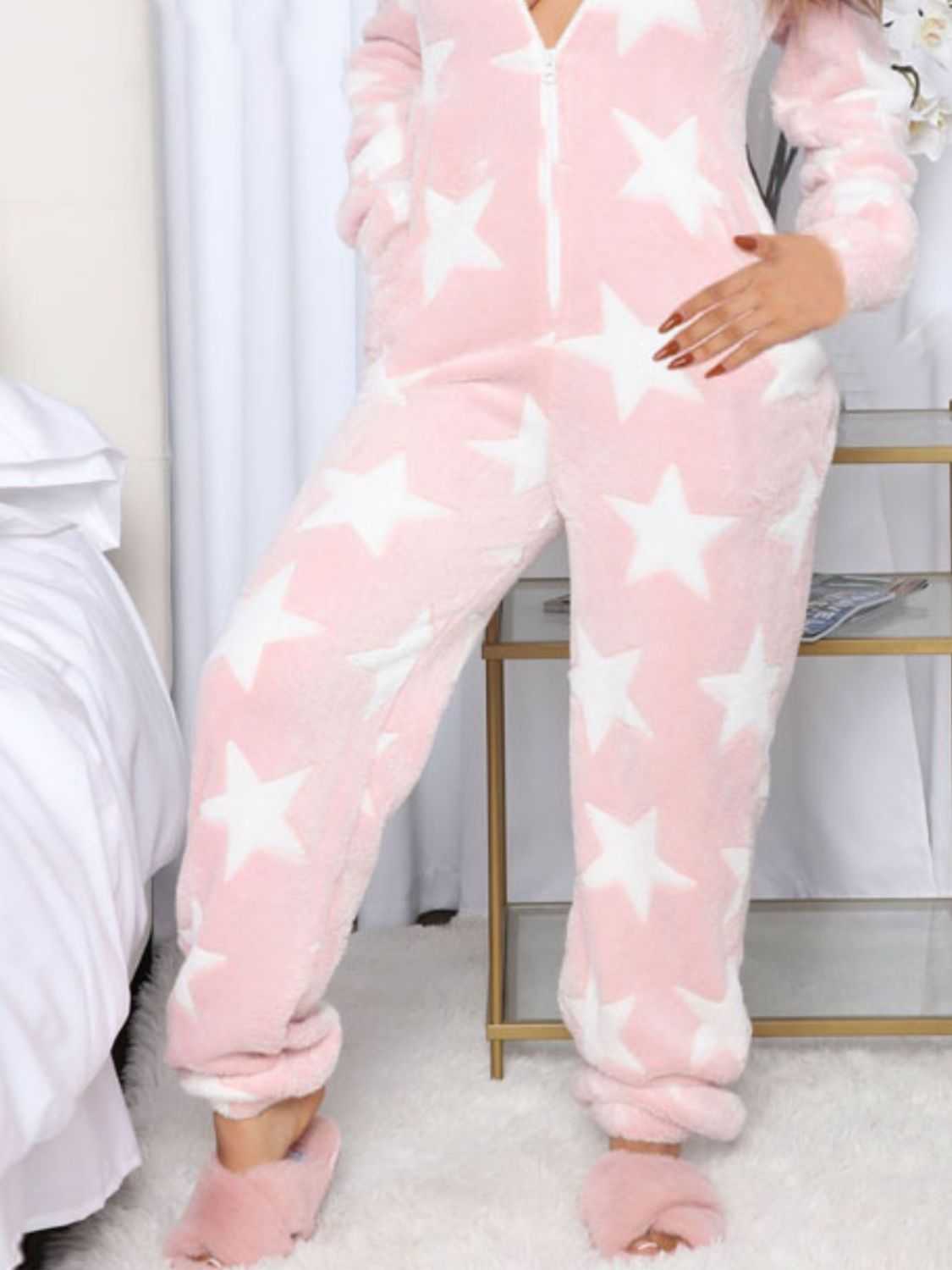 Pink star-printed long sleeve hooded lounge jumpsuit with pockets.