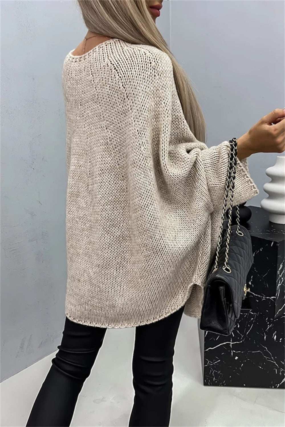 Round neck batwing sleeve sweater in light beige, women's fashion attire.