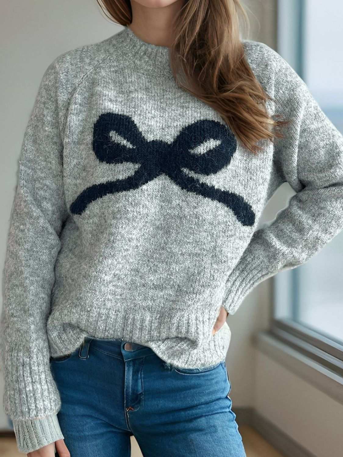 Bow Round Neck Long Sleeve Sweater with navy bow design, slightly stretchy, polyester-acrylic material.