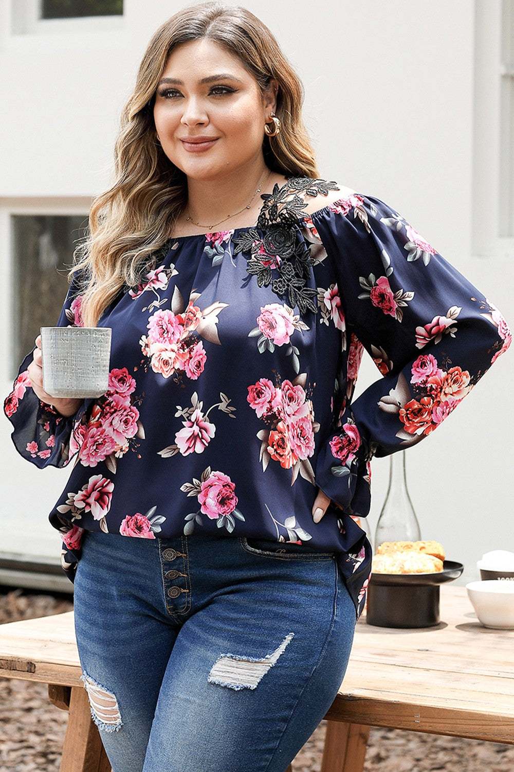 Plus size floral flounce sleeve blouse, polyester, worn by a woman holding a mug.