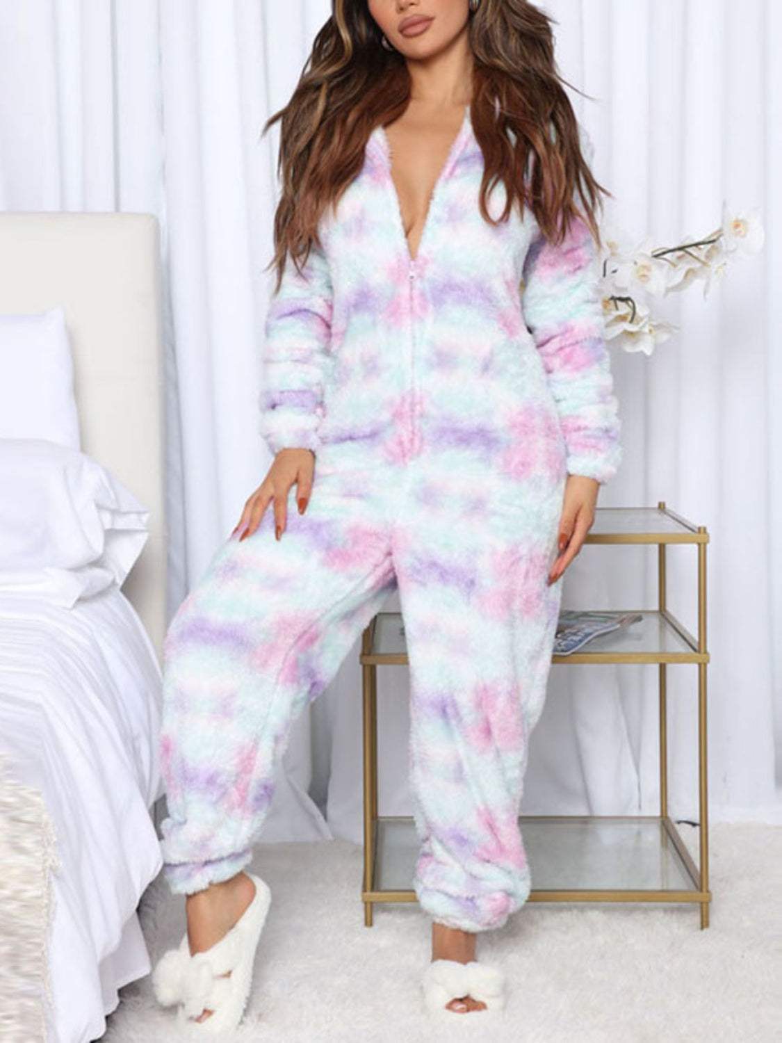 Cozy long sleeve hooded lounge jumpsuit with zip-up design and pastel print.