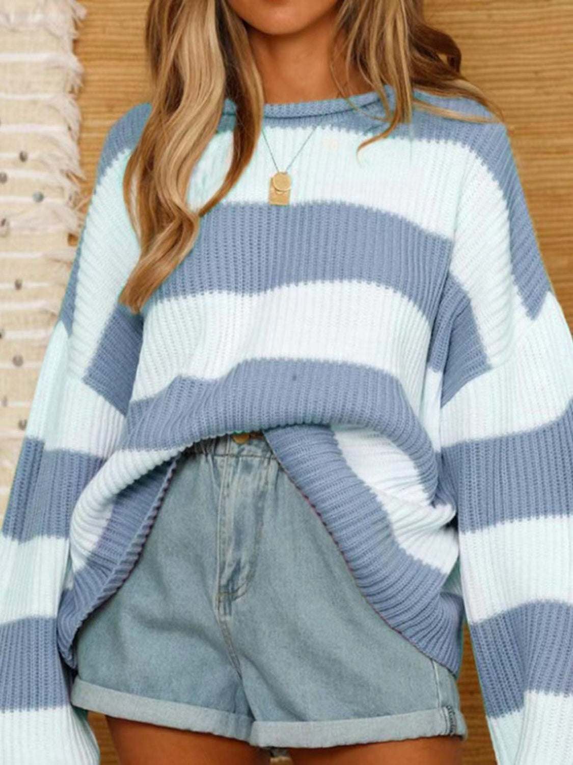 Round neck long sleeve sweater in blue and white stripes.