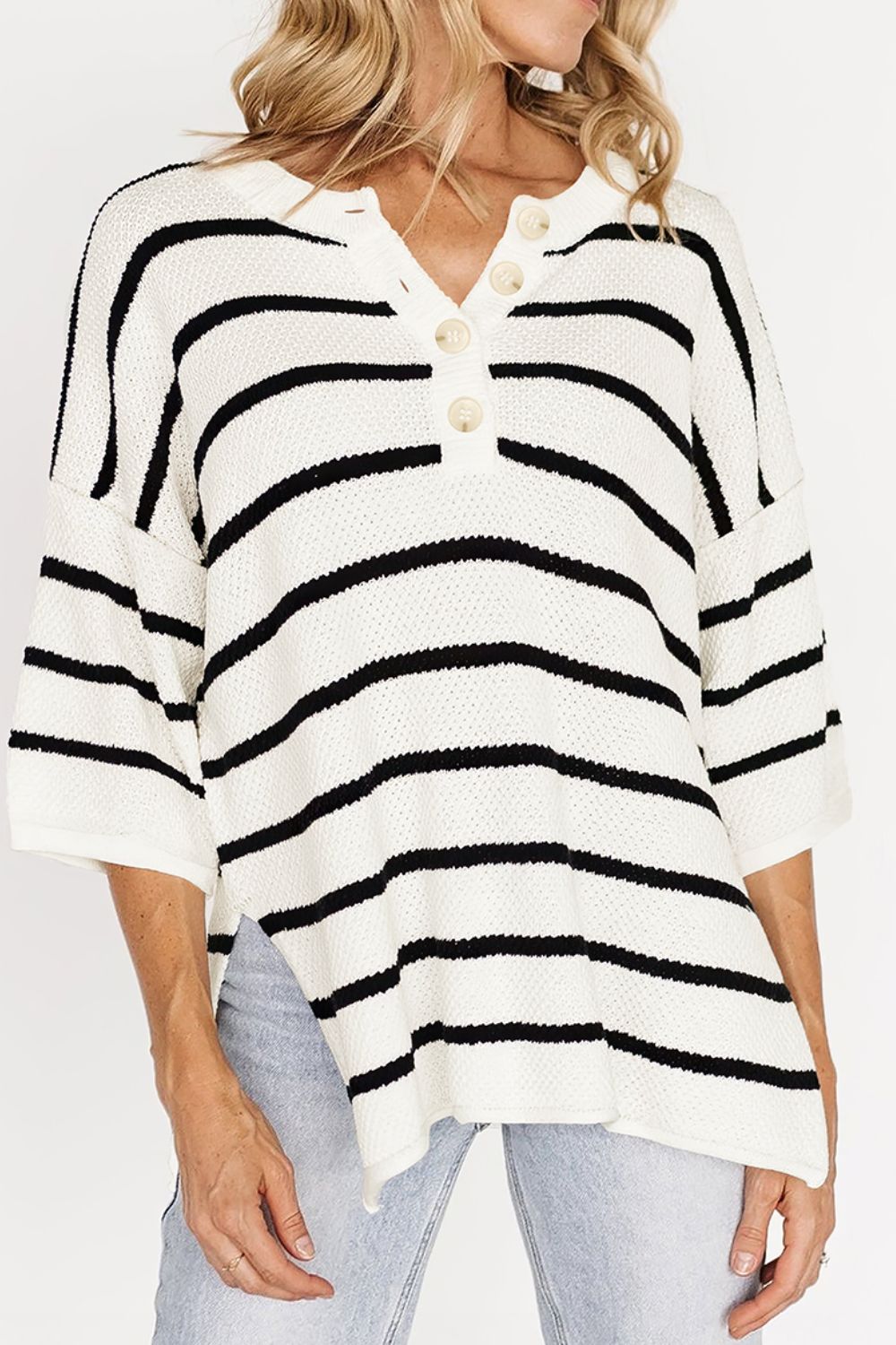 White and black striped drop shoulder knit top with buttoned V-neck and side slit, slightly stretchy viscose fabric