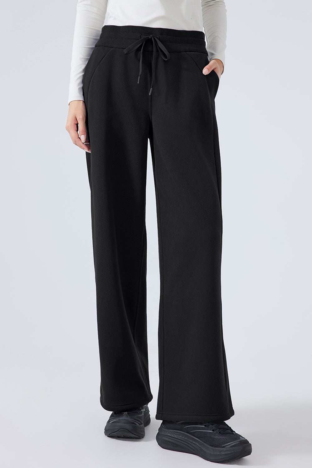 Black Millennia Drawstring wide leg pants made of polyester and cotton blend with an adjustable waist.