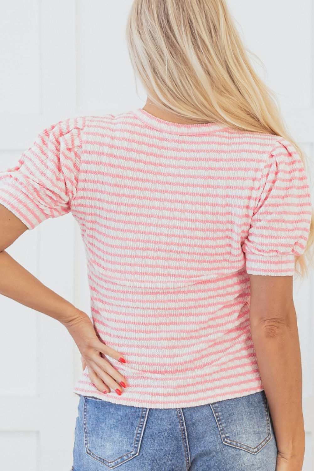 Stripe textured puff sleeve blouse with a crewneck in pink and white, shown from the back.