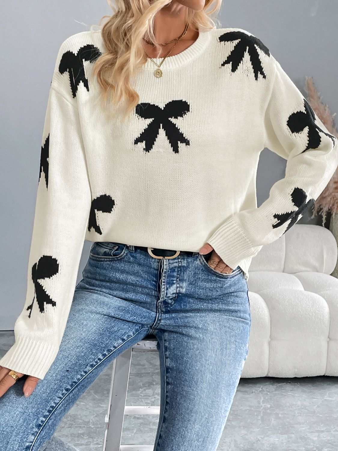 Perfee Bow Graphic Round Neck Long Sleeve Sweater with black bow designs, moderate stretch, 100% acrylic.