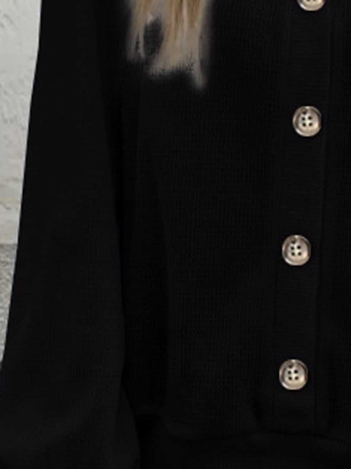 V-neck dropped shoulder blouse, solid black waffle-knit, casual style with buttons.