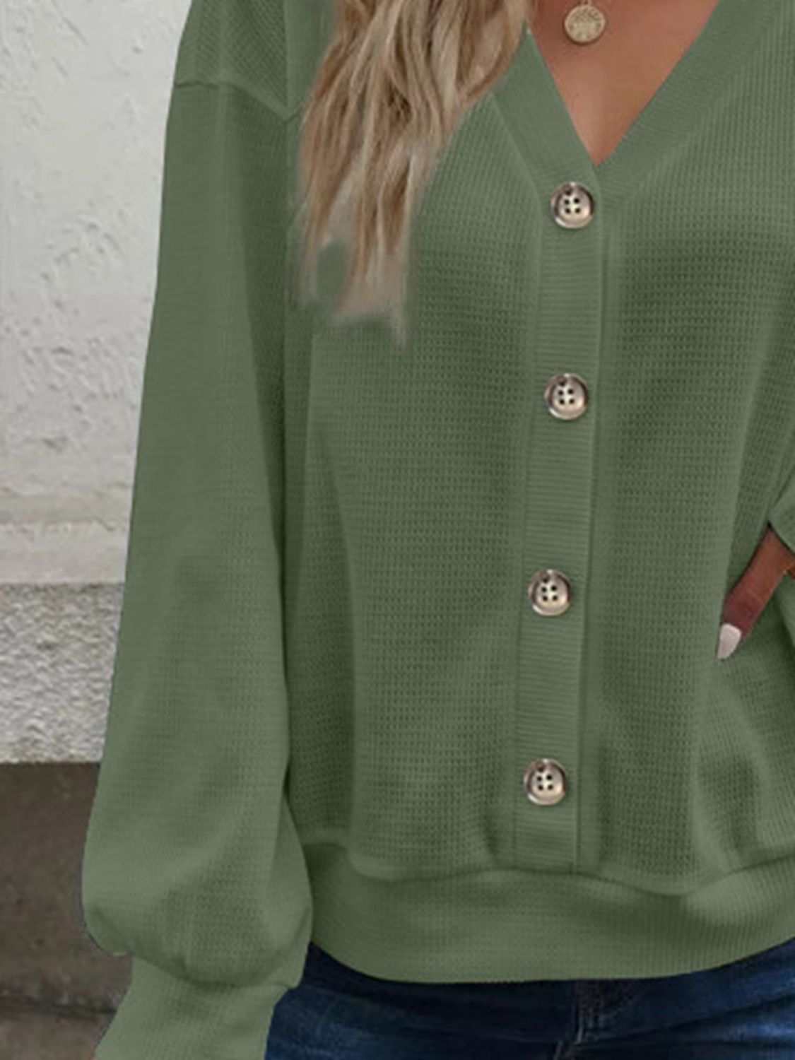 Solid waffle-knit V-neck blouse with dropped shoulders and long sleeves.