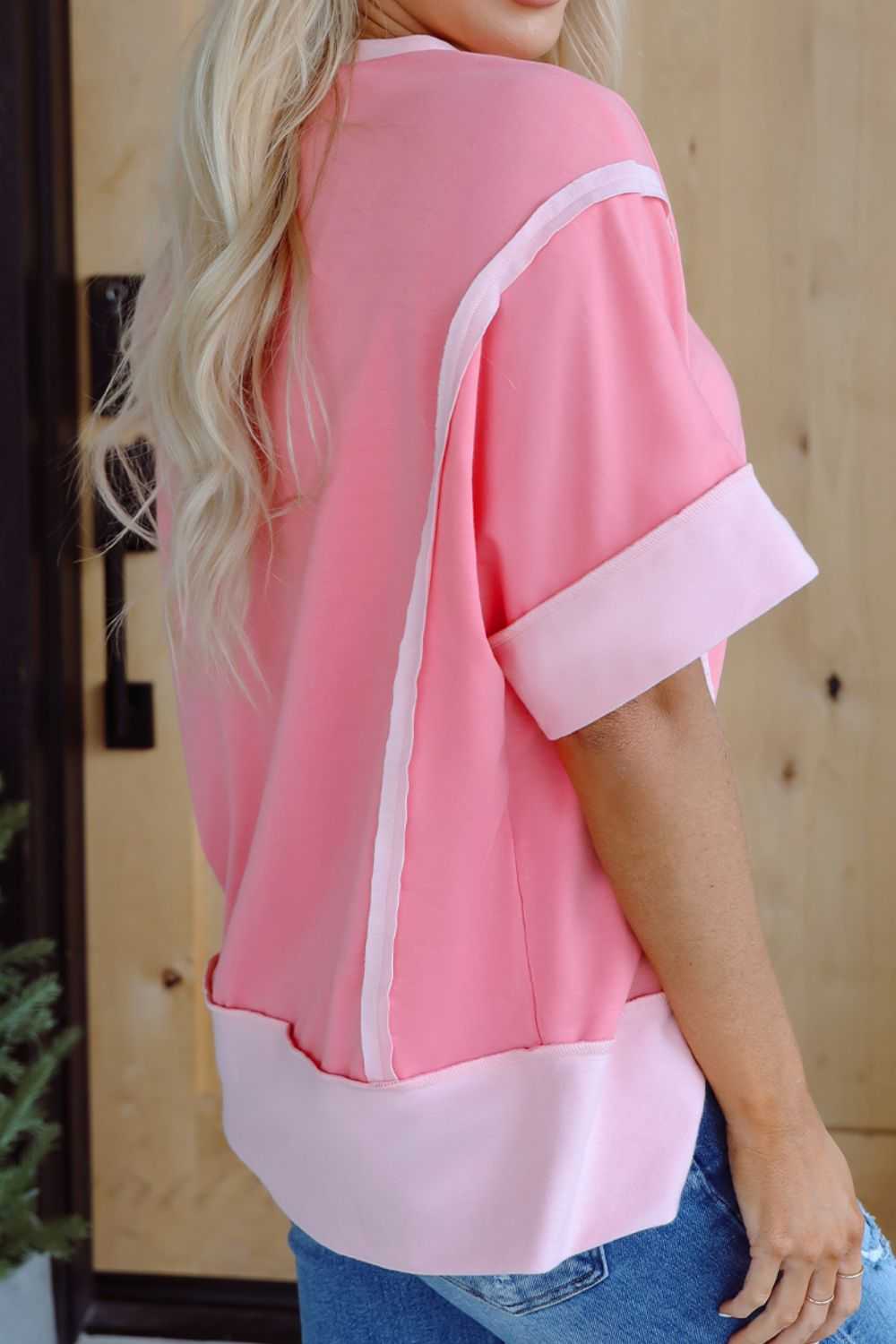 Pink short sleeve T-shirt with sequined Easter egg design, exposed seam, slightly stretchy fabric.