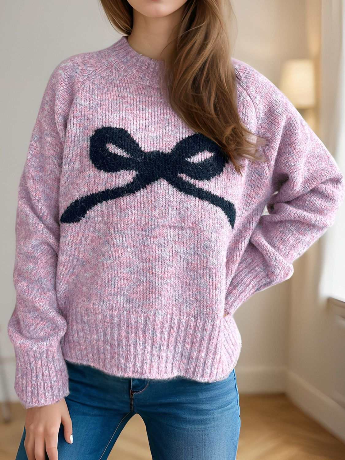 Bow round neck long sleeve sweater, slightly stretchy, pink with black bow design.