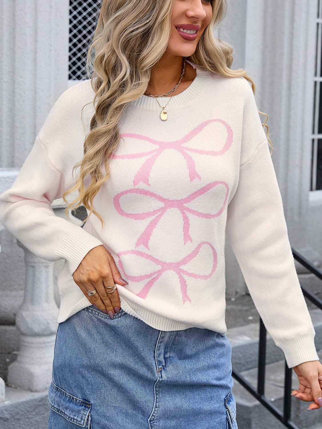 Angel Wings Bow Graphic Round Neck Long Sleeve Sweater with pink bow design.