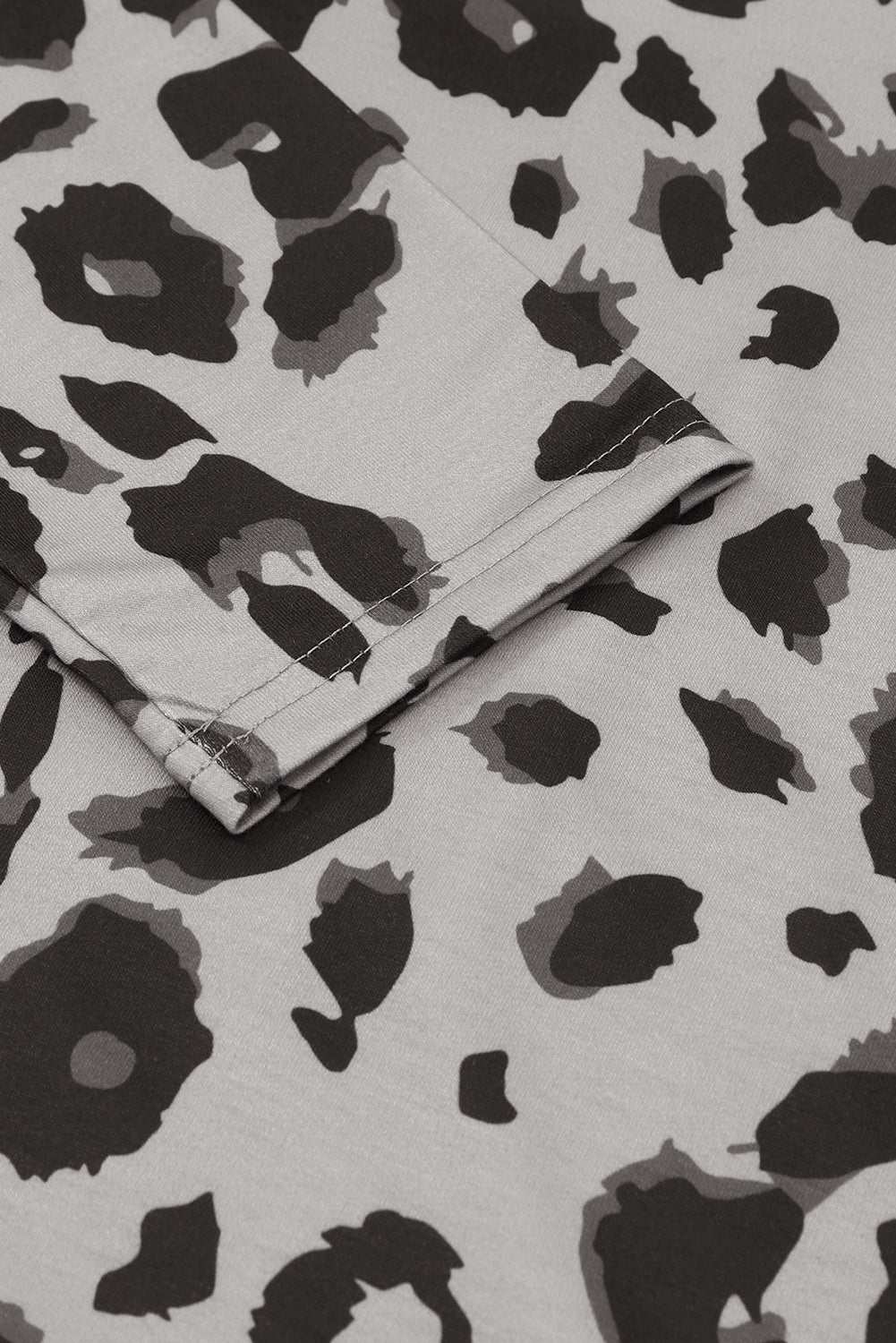 Leopard print V-neck dropped shoulder blouse fabric close-up.